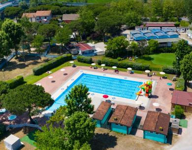 Aerial view of an outdoor pool with play area and umbrellas.