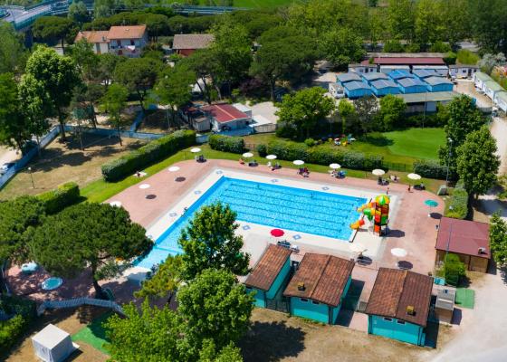 Aerial view of an outdoor pool with play area and umbrellas.